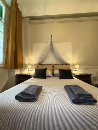 a bedroom with a large bed with two towels on it at Guest House Santa Giustina Lucca Centro Storico in Lucca