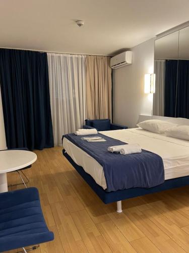 a hotel room with a bed and a table at Orbi city bloke A in Angisa