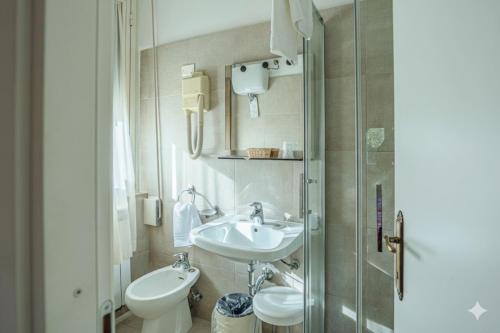 a bathroom with a sink and a toilet and a shower at Hotel Paradiso in Monteluco