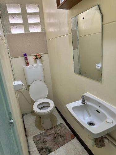 a bathroom with a toilet and a sink at Peaceful Place 1 in Nairobi