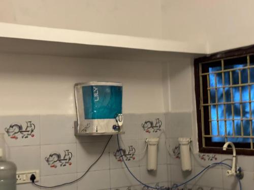 a tv on the wall of a bathroom at Townhouse 4bhk Bungalow - TIE Hotels in Pondicherry