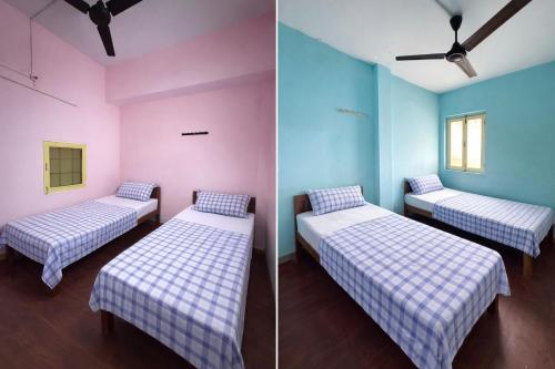 two beds in a room with pink and blue at Nook Coliving Male Only in Lucknow