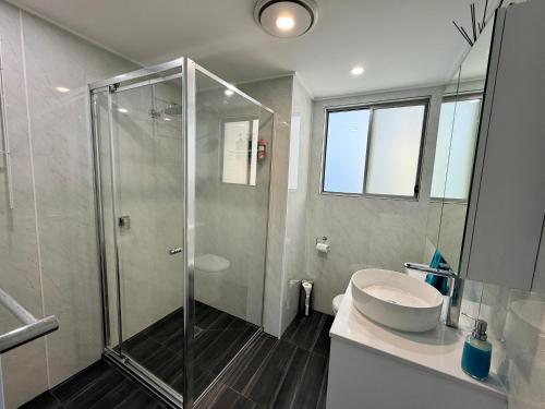 a bathroom with a shower and a sink at Tiny House in Belconnen 1BR Self Contained Complete Home Filtration as seen on The Block Phillip Island Wine in Higgins