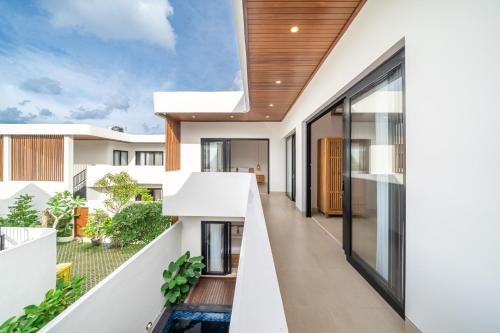 an external view of a house with a balcony at Cassandra Villas - Tropical Private Pool Escape near Beach in Sanur