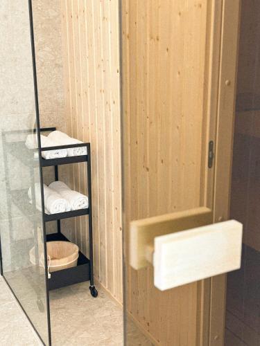 a bathroom with a rack of towels and a mirror at Lombtér in Pásztó
