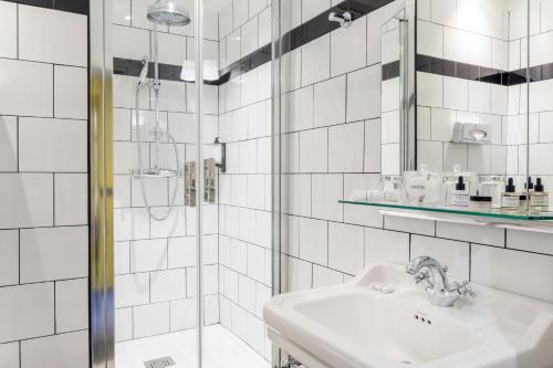 a white bathroom with a sink and a shower at Best Western Premier Hotel Roosevelt in Nice