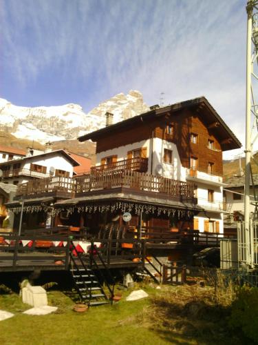 a large building with a balcony in front of a mountain at Cervinia in Breuil-Cervinia