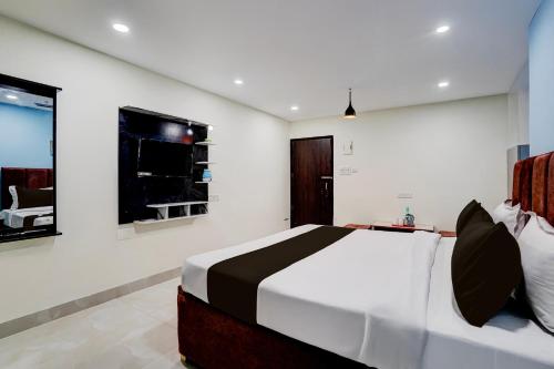 a bedroom with a large bed in a room at Hotel O Khusi Tranquil Domicile in Bhubaneshwar