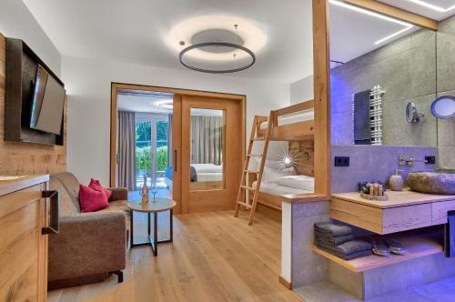 a room with a bunk bed and a living room at Resort Hotel Bodenmais in Bodenmais