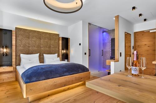 a bedroom with a large bed with a blue blanket at Resort Hotel Bodenmais in Bodenmais
