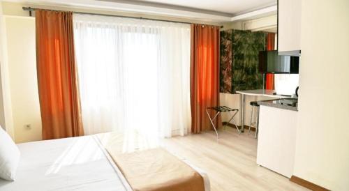 a hotel room with a bed and a kitchen at Terra Suites in Istanbul