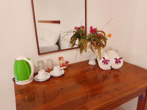 a table with a mirror and some dishes on it at Zendora Resort Yala in Tissamaharama