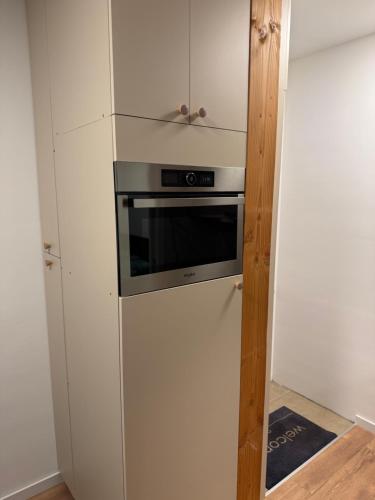 a kitchen with a refrigerator and a microwave at Arnhem Bouwmeesterstraat in Arnhem