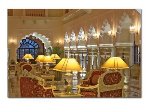 a large room with chairs and tables and lamps at Shiv Vilas Resort in Jaipur