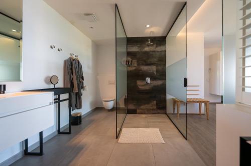 a bathroom with a glass shower and a toilet at Atholl House in Cape Town