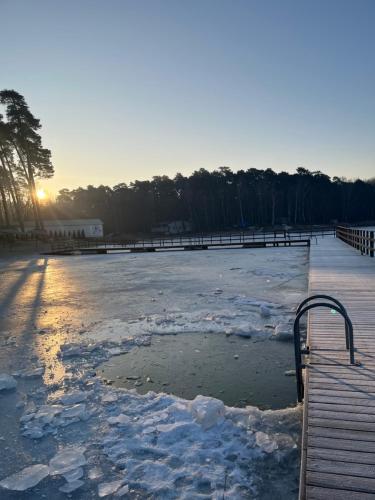 an ice hockey rink with snow on it at Apartamenty Leśne Historie in Gołuchów