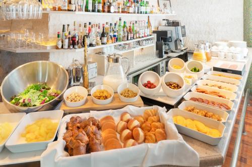 a buffet with many different types of food in trays at Villa Fontaine Grand Tokyo Roppongi in Tokyo
