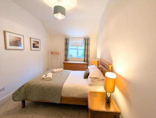 a bedroom with a large bed and a window at 2 Bedroom Unique Converted Constabulary in Nantwich