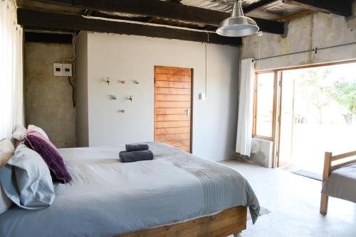 a bedroom with a large bed and a large window at The Prawn Hatchery Pty Ltd on Amatikulu in Dokodweni
