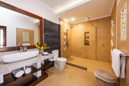 a bathroom with a sink and a shower at Bunaken Oasis Dive Resort and Spa in Bunaken