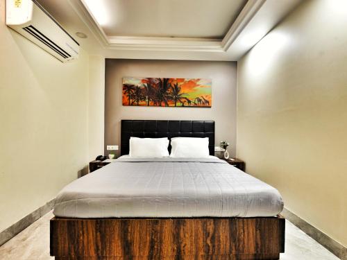 a bedroom with a large bed in a room at Hotel Aerocity Purple Orchid in New Delhi