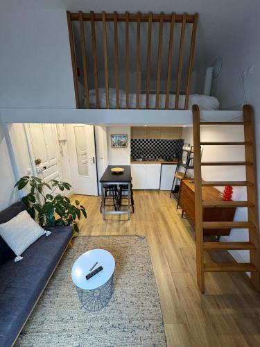 a living room with a bunk bed and a couch at Studio Biarritz Côte des Basques in Biarritz