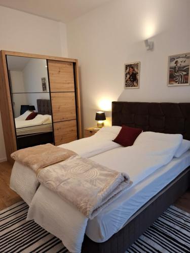 a bedroom with two beds and a large mirror at Terrace Apartmani in Široki Brijeg