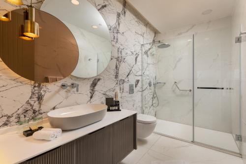 a bathroom with a sink and a shower at Unique Life Style Hotel in Kuşadası