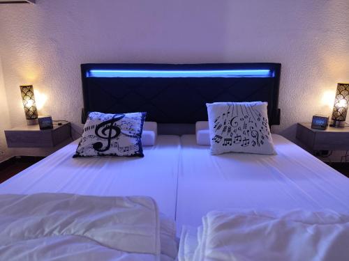 une chambre avec un lit avec deux oreillers dessus dans l'établissement Le Tau, à Saintes-Maries-de-la-Mer