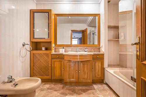 a bathroom with a sink and a mirror and a tub at Can Maro in Santa Margalida