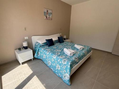a bedroom with a bed with two towels on it at Acquaviva Suite in San Vincenzo