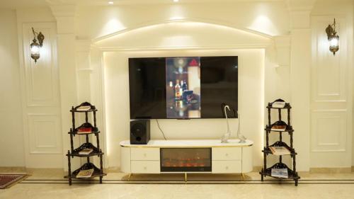 a living room with a tv on top of a dresser at Hotel Royal Palace in Sāgar