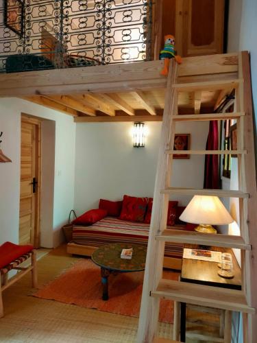 a living room with a loft bed and a couch at La Maison des Amis in Fez
