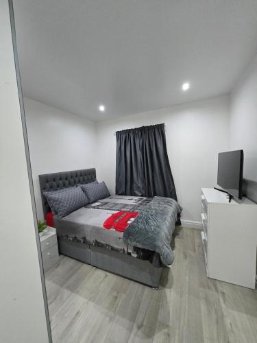 a bedroom with a bed and a television in it at Luxury One Bedroom En-suite with Free Parking in Harrow Weald