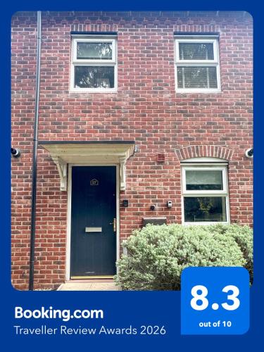 a brick building with a blue door on it at Family home close to Shrewsbury Town centre in Shrewsbury