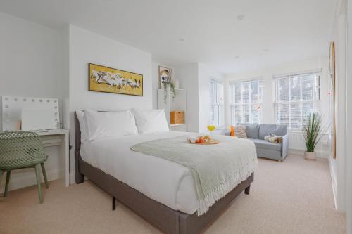 a bedroom with a bed with a table and a chair at Beachway House in Weymouth