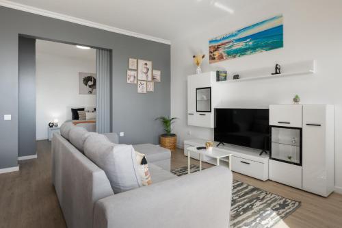a living room with a couch and a tv at Casa Jorge Calaça by An Island Apart in Caniçal