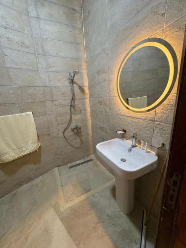 a bathroom with a sink and a mirror at SiwaTu Lodge in Siwa