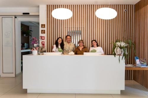 a group of people standing behind a counter at Hotel Romagna in Cattolica