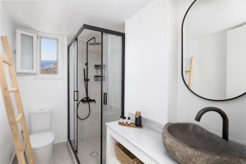 a bathroom with a sink and a shower at Occhio-Nero Cycladic Private Villa with Pool & Sunset View Jacuzzi in Akrotiri