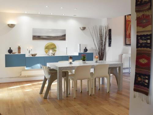 a dining room with a table and chairs at Alices Cottage in Stepaside