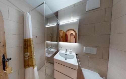 a bathroom with a sink and a mirror at Champagna in Celerina