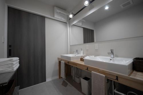 a bathroom with two sinks and a mirror at AWAJI PRIVATE Villa 神蔵-KAGURA in Awaji