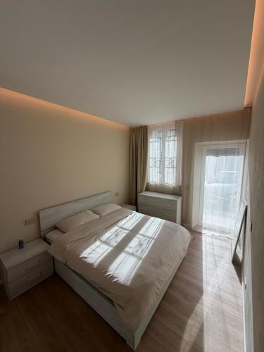 a bedroom with a white bed and a window at Milan house 2 in Samarate