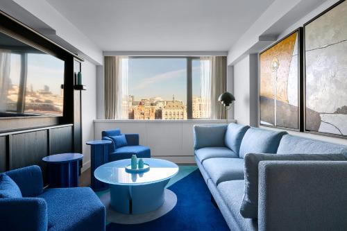 a living room with a couch and chairs and a table at Sea Containers London in London