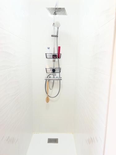 a shower in a white bathroom with a showercolo at Guedon sandrine in Grosley-sur-Risle