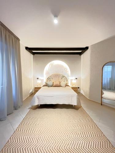 a bedroom with a bed and a large rug at Aura Suites Napoli in Naples