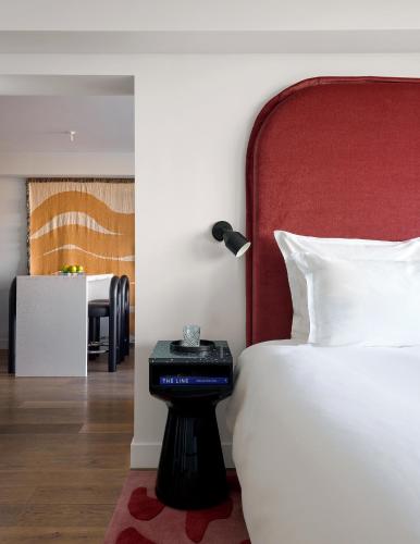 a bedroom with a bed and a table with a lamp at Sea Containers London in London