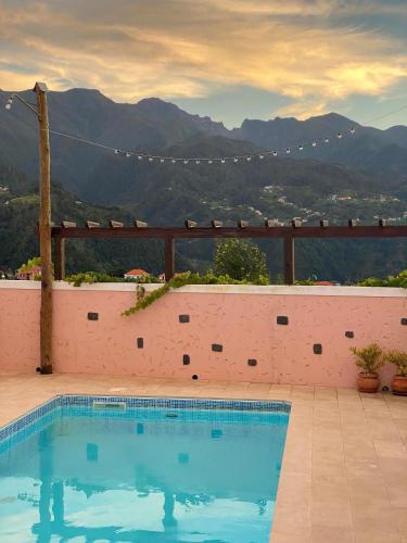 a swimming pool with a view of a mountain at Quintinha do Álvaro - Holiday house in Santana