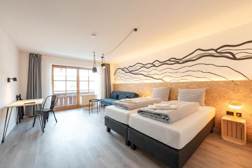 a bedroom with two beds and a living room at Weitnau Stays - Hotel & Hostel in Weitnau